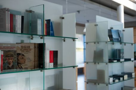 Books are offered for sale on glass shelves.
